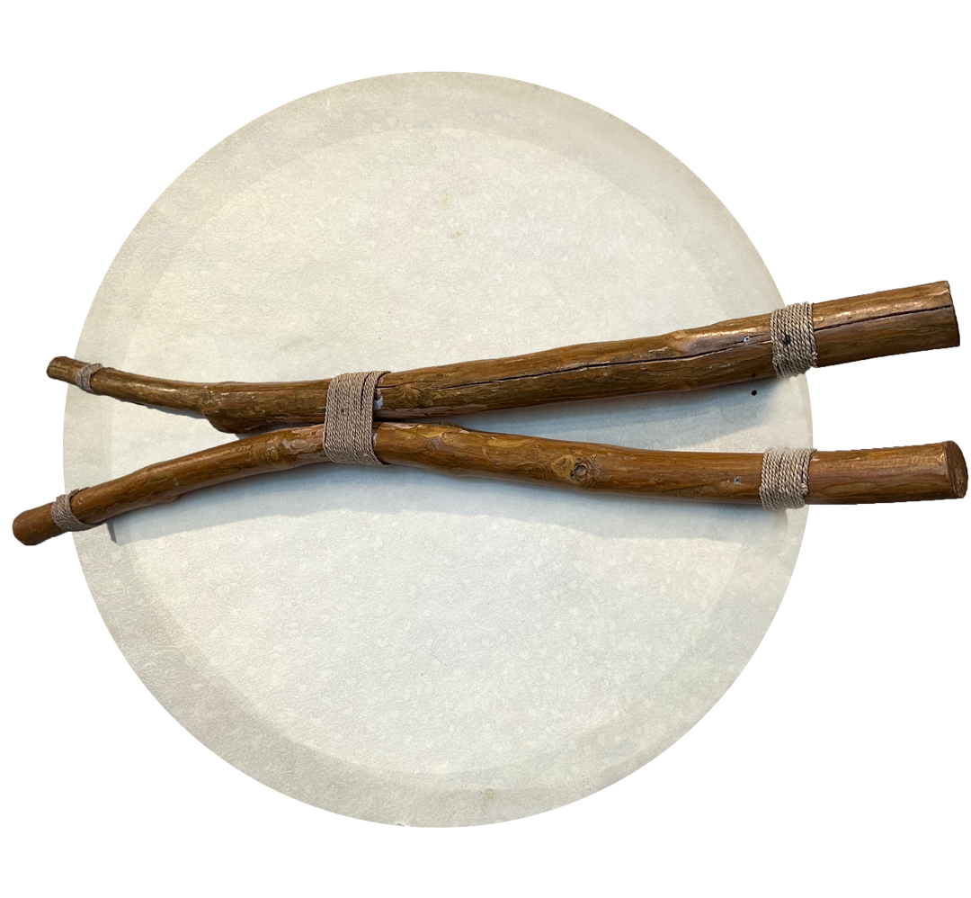 Two wooden sticks with a natural finish, bound together at two points with a light-colored cord, lie on a white circular surface. The sticks, much like the intricate cases handled by Fairfield County Divorce Lawyers, have a rustic, uneven texture, emphasizing their handcrafted appearance.